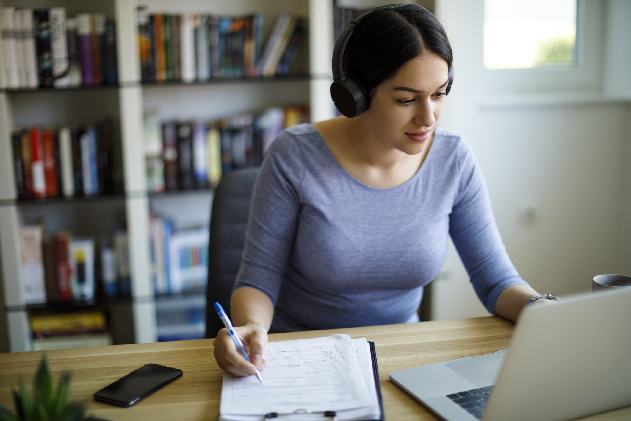 Woman with headphones in front of laptop.jpg